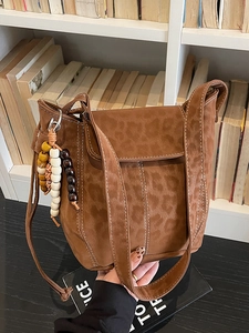 Vintage brown leopard print suede bucket bag with bohemian beads and contrast stitching