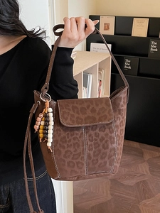 Vintage leopard print bucket bag in brown matte finish with decorative stitching