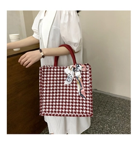 Detail of red and white houndstooth tote bag with a vintage horse carriage print silk scarf