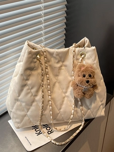 White large capacity quilted tote bag with gold chain straps and a cute brown charm