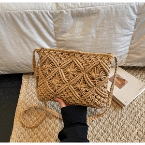Macro view of macrame woven bag showing intricate khaki geometric knots and tassels