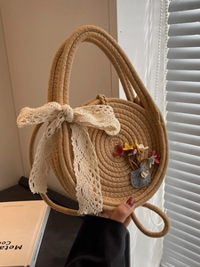 Handmade round straw woven beach bag with beige lace bow and floral embroidery detail