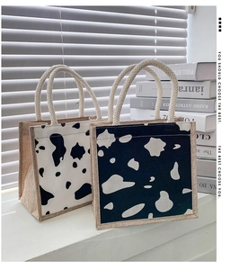 Detail of cow print canvas lunch bags with thick woven rope handles and hemp texture