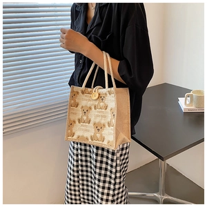 Detail of cute bear printed canvas lunch bag with cotton rope handles and wood button