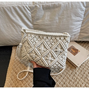 Detailed close-up of handmade macramé woven texture and floral patterns on a bohemian bag