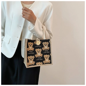 Close-up of cute cartoon bear printed linen tote bag with distinctive large wooden button