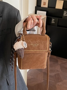 Brown matte leather crossbody bag with metal rivets and a cute ice cream charm