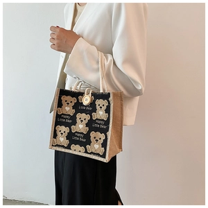 Linen tote bag with black canvas bear print and round wooden button closure