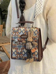 Vintage quilted backpack with NAN XIAO JIE branding and cute rabbit charm on a model
