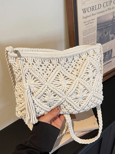 Handmade cream macramé envelope beach bag with geometric weave and tassel zipper