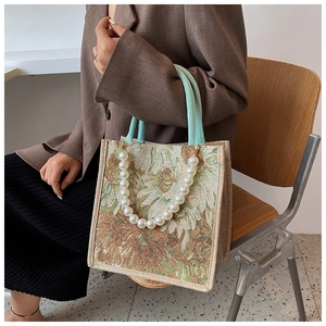 Artistic tote bag with Van Gogh sunflower print and decorative white pearl strap detail