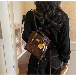 Detail van de koffiebruine retro PU-leren tas met metalen gesp en baseball hanger