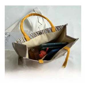 Top view of spacious linen tote bag interior with magnetic snap closure and yellow handles