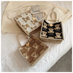 Detailed texture of linen tote bags with cute bear prints and sturdy rope handles