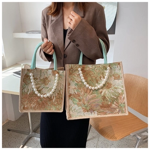 Detailed comparison of two vintage floral tote bags with pearl handles and rope straps