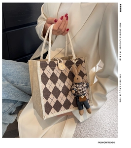 Close-up of linen tote bag with brown argyle pattern and a cute bunny plush charm