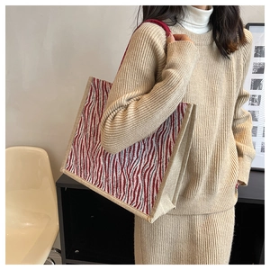 Detail of red and white wave pattern large capacity tote bag with woven shoulder straps