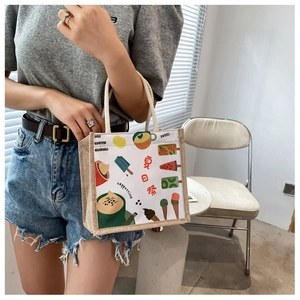 Detail of canvas bento bag featuring cartoon summer prints and thick woven rope handles