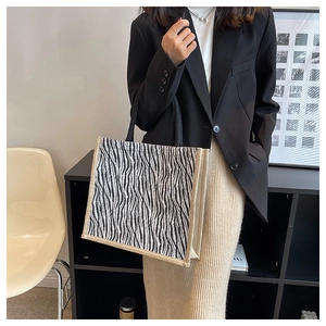 Chic zebra pattern tote bag in canvas fabric paired with a modern professional outfit