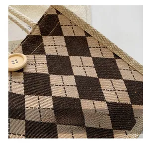 Macro detail of checkerboard linen bag with wooden button and braided rope handle