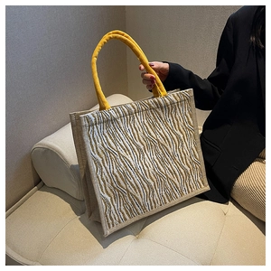 Detailed close-up of a large linen tote bag featuring animal print and rope handles