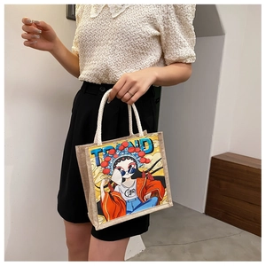 Detail of jute tote bag featuring modern oriental graphic and white cotton rope handle