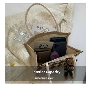 Spacious interior of linen tote showing capacity for phone, wallet and notebook