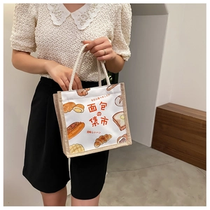 Detail of canvas and jute tote bag with cute bread illustrations and soft rope handles