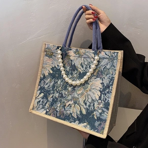 Floral jacquard tote bag with large pearl chain decoration and blue rope handles