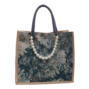 Floral jacquard tote bag with purple woven handles and a decorative pearl chain strap