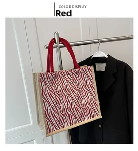 Detail view of large linen tote bag with red zebra stripes and thick rope handles