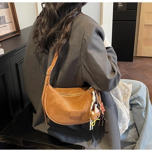 Brown retro half-moon crossbody bag with cute bear charm and star tassels detail