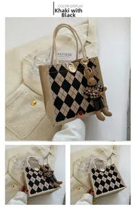 Close-up of khaki and black quilted canvas tote with knit rabbit charm and rope handle