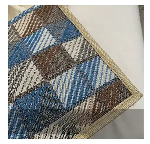 Macro view of blue and brown checkered linen tote bag with reinforced white stitching