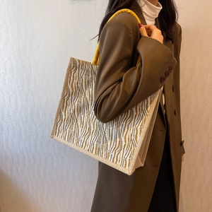 Large linen tote bag with yellow wavy pattern and knotted handles for daily commute