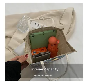 Spacious interior of beige linen tote showing room for tablet, umbrella and wallet