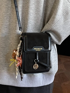 Minimalist black faux leather crossbody phone bag with stylish scarf and bear pendant