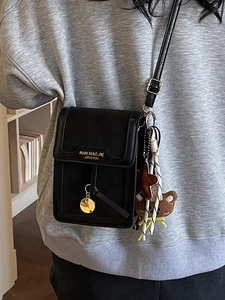 Minimalist black leather small crossbody bag for women with charms and teddy bear pendant