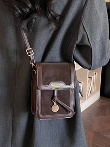 Minimalist dark brown leather crossbody bag with adjustable strap for women in office