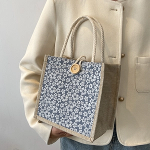 Vintage floral canvas and linen tote bag for women featuring wooden button and top handles