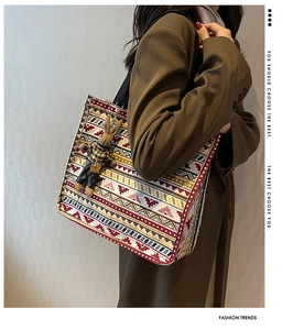Detailed shot of ethnic canvas tote with geometric prints and cute rabbit charm