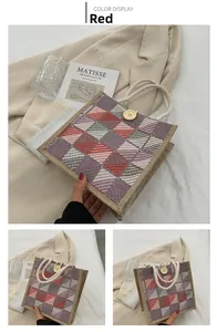 Detail of red checkered canvas tote bag with woven rope handles and a large wooden button