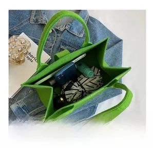 Felt tote bag interior showing large capacity for phone, umbrella and daily essentials