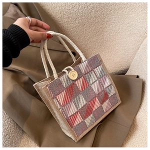 Detail of red and grey checkered linen handbag with thick cotton rope handle and button