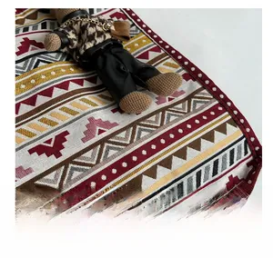 Detailed view of ethnic geometric woven fabric with red and black triangular patterns