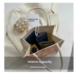 Internal capacity of the canvas lunch bag showing space for phones, wallet and bottle