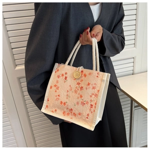 Detail of floral lace tote bag with wooden button and white cotton rope handles