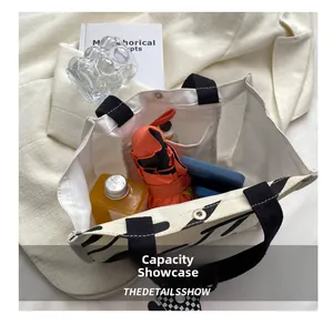 Detail of canvas tote bag interior showing large capacity for umbrella and daily items