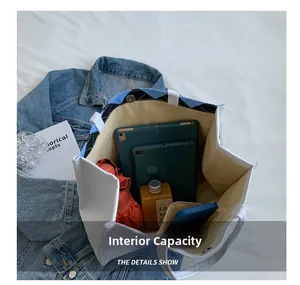 Interior capacity of canvas tote bag with tablet and daily essentials in side pocket