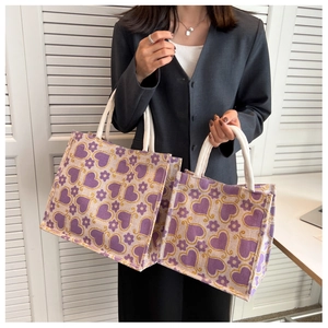 Detail of two-piece tote bag set with purple heart print and beige rope handles